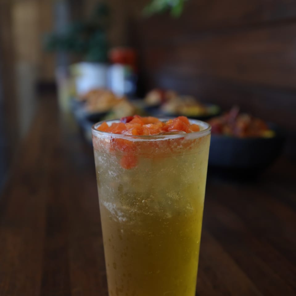 Mango fruit iced drink topped with diced fresh fruit.